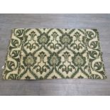 A green and cream Art Deco wall hanging