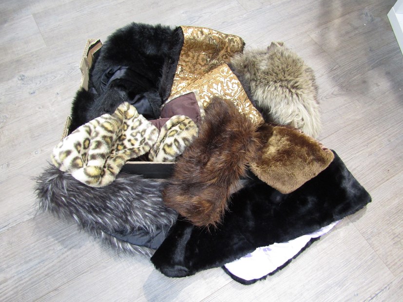 A box containing fur items including stoles,