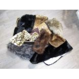 A box containing fur items including stoles,