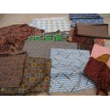 A small quantity of small scale swatches of geometric and African prints for men's wear