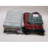 Two bundles of dress making fabric and wool tartans