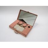 A 1950's pink metal motorists travelling vanity set by Sirrain Ltd