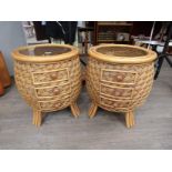 A pair of bamboo and rattan kitsch style conservatory/bedroom circular tables with smoked glass