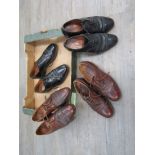 Two pairs of black leather Oxford shoes and two pairs of tan leather lace ups