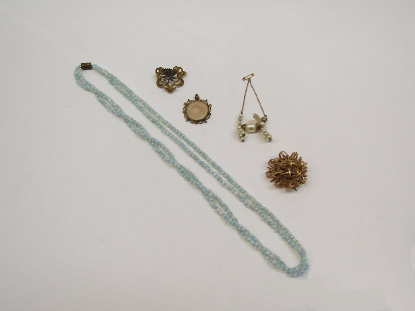 Five items of Middle 20th Century costume jewellery including a pearl articulated brooch in the