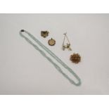 Five items of Middle 20th Century costume jewellery including a pearl articulated brooch in the