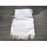 Two white cotton single size waffle effect bedspreads both with fringing,