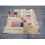 A Victorian quilt made up of various fabric remnants