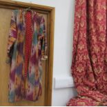 An early to mid 20th Century Ikat silk coat, hand stitched throughout,
