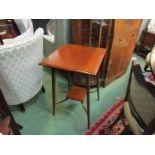 An Edwardian chequer strung mahogany two tier lamp table on square tapering legs,