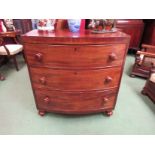 An early Victorian mahogany bow front chest of three graduating long drawers on turned feet (minor