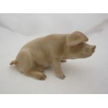 A Copenhagen porcelain figure of seated pig, marked 1582A to base,