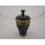A Royal Crown Derby porcelain small lidded jar painted in gilt of a gros bleu ground.