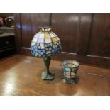 A leaded stained glass candle lamp and another