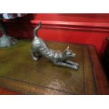 A figure of a cat stretching