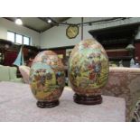 Two Satsuma decorative eggs on stands,