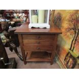 A circa 1920 walnut two tier work table of three drawers on square tapering reeded legs (inlaid