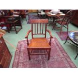 Circa 1820 an elm and oak elbow chair with reeded slab and turned arm supports,