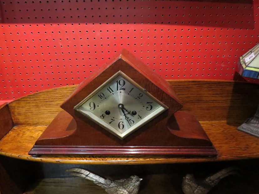 An Art Deco mantel clock, diamond shaped silvered dial,