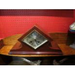 An Art Deco mantel clock, diamond shaped silvered dial,