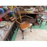 A pair of elm stick and wheel back elbow chairs with crinoline stretchers on pad front feet