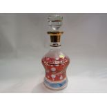 A Bohemian cut glass decanter with red and blue tint,