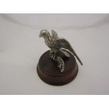 An early 20th Century silver plated eagle car mascot on a wood plinth
