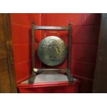 An early 20th Century oak framed dinner gong on stand with beater, 71cm high x 49.