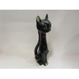 A stylised black figure of a cat with elongated neck,