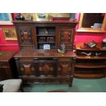 An 18th Century oak and walnut veneer court cupboard with linen fold side panels,