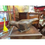 A carved wooden pigeon on stand,