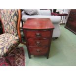 A George III style mahogany bow front bedside chest of three drawers with reeded decoration over