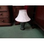 A decorative baluster form table lamp, green ground with blue foliate pattern,