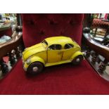 A tinplate VW Beetle model,