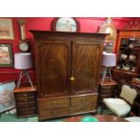 An early Victorian mahogany full hanging wardrobe the two doors over faux base drawers on bracket