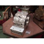A National Cash Register, nickel plated case, model 348, serial no. 943030, made in 1911.