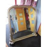 A silvered domed top over mantel mirror,
