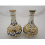 A pair of 19th Century Derby porcelain small bottle vases painted in blue and gilt on a white