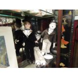 Three collectors' dolls including Laurel & Hardy with stands