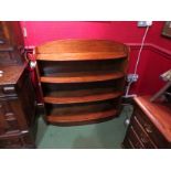 Circa 1920 an oak bow front four tier bookshelf,