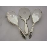 A Charles Henry Dumenil silver three piece dressing table set consisting of hand mirror and two