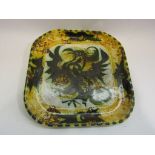 A square glazed "Newlyn" pottery shallow tray depicting a Phoenix,