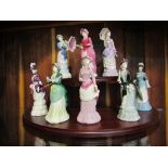 A set of eight Coalport lady figures with display stand