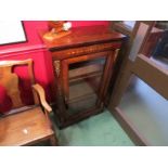 Circa 1840 an inlaid rosewood pier cabinet with brass ormolu mounts the single glazed door with key