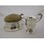 A Victorian silver pin cushion together with a twin handled miniature trophy cup (2)