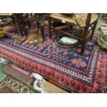 A blue and red ground rug with multiple borders,