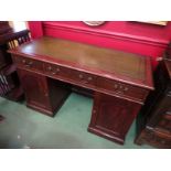 A 19th Century mahogany twin pedestal desk the tooled leather writing surface over three frieze