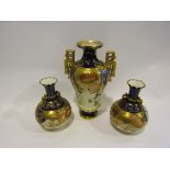 A pair of Royal Crown Derby porcelain vases decorated in the Imari palette on a cream ground.