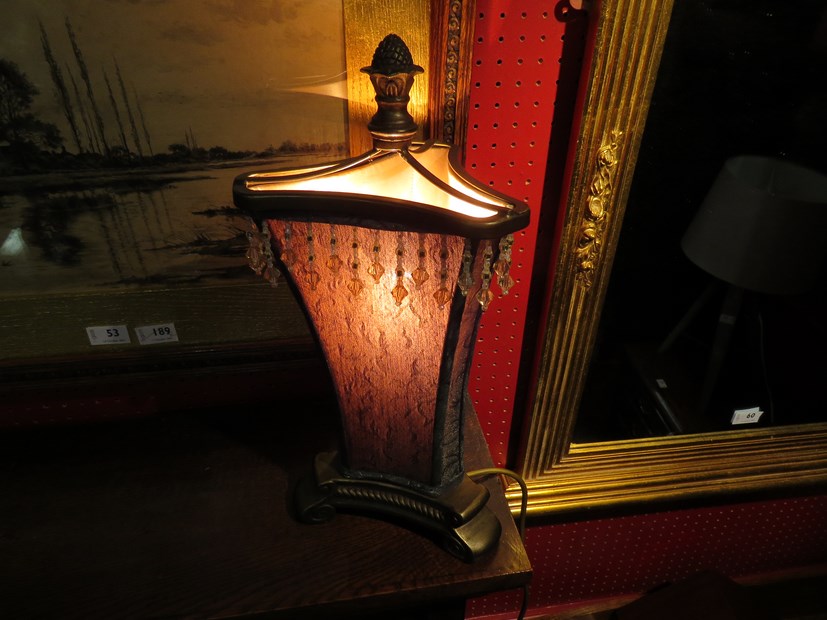 A table lamp with embroidered shade and beaded fringe