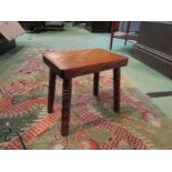 An early 19th Century fruitwood stool on bobbin turned legs,